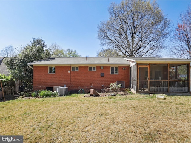 905 Peele Pl, Alexandria, VA 22304 - back of house with central AC unit, a sunroom, a lawn, and brick siding