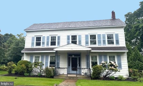 1512 River Rd, Upper Black Eddy, PA 18972 - view of front of home featuring a chimney and a front lawn