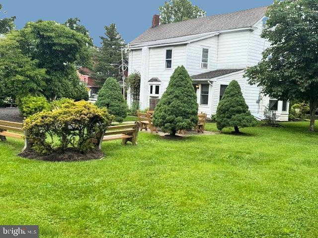1512 River Rd, Upper Black Eddy, PA 18972 - rear view of property featuring a yard and a chimney