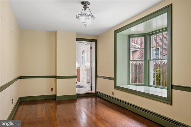 28 The Strand, New Castle, DE 19720 - spare room with a baseboard radiator, wood-type flooring, and baseboards