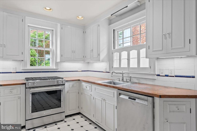 28 The Strand, New Castle, DE 19720 - kitchen with stainless steel appliances, a sink, wooden counters, healthy amount of natural light, and recessed lighting