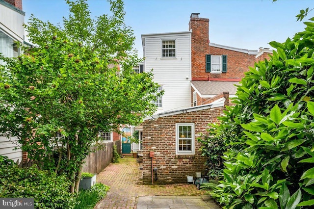 28 The Strand, New Castle, DE 19720 - rear view of property featuring a chimney and brick siding