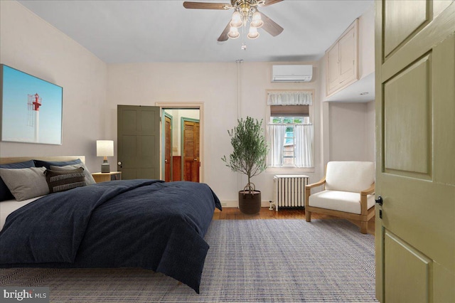 28 The Strand, New Castle, DE 19720 - bedroom with radiator heating unit, a wall unit AC, wood finished floors, baseboards, and ceiling fan