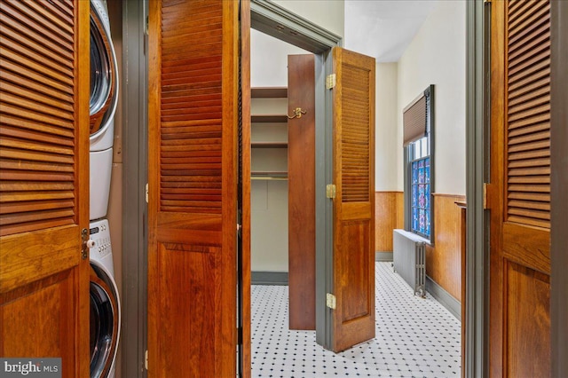 28 The Strand, New Castle, DE 19720 - corridor featuring stacked washer and clothes dryer and wainscoting