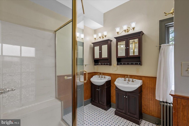 28 The Strand, New Castle, DE 19720 - bathroom with wainscoting, a shower stall, tile patterned floors, two vanities, and wooden walls