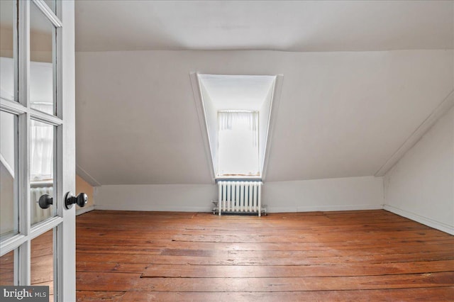 28 The Strand, New Castle, DE 19720 - additional living space with radiator heating unit, hardwood / wood-style floors, and lofted ceiling