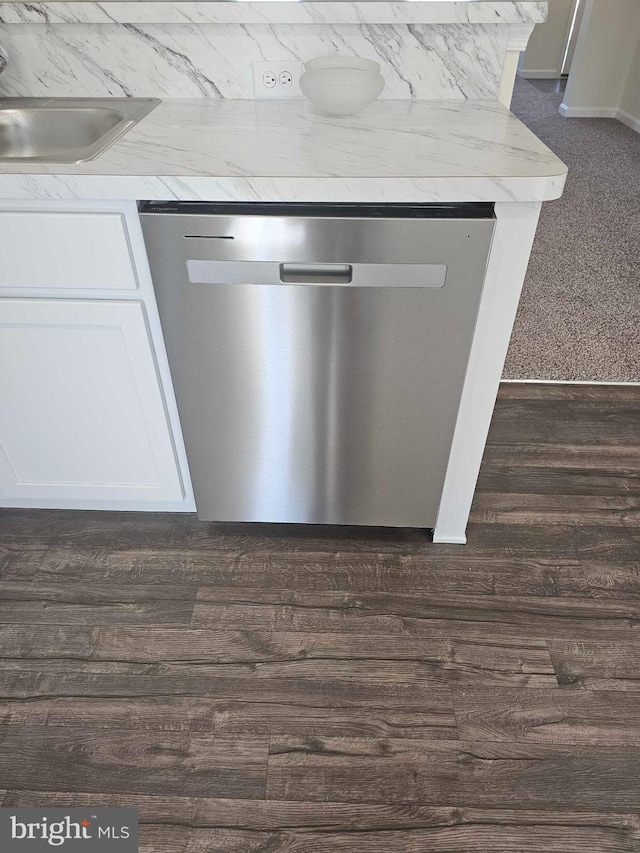 241 Rojan Rd Unit 114, Dover, DE 19901 - kitchen view of stainless steel dishwasher, a sink, white cabinets, dark wood-type flooring, and light countertops