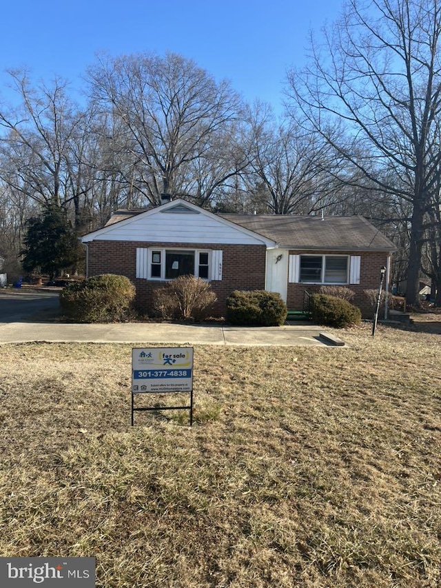 6640 Pomfret Rd, La Plata, MD 20646 - view of front of house featuring brick siding and a front lawn