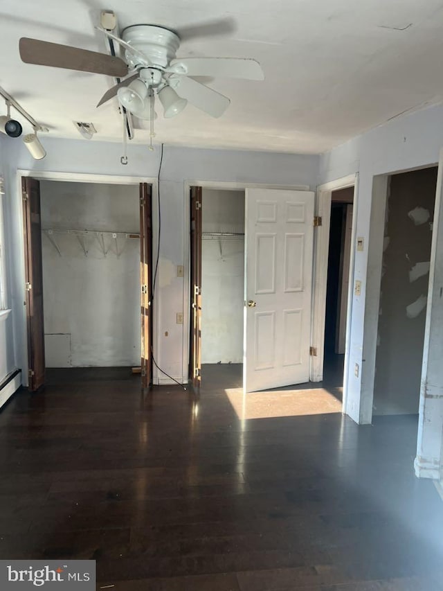 6640 Pomfret Rd, La Plata, MD 20646 - unfurnished bedroom featuring wood finished floors, multiple closets, and ceiling fan