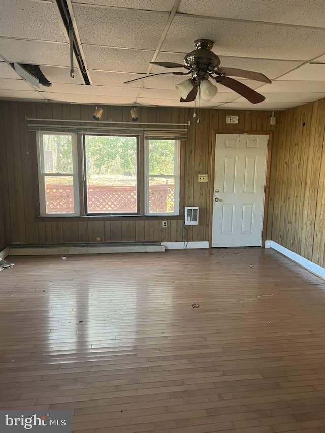 6640 Pomfret Rd, La Plata, MD 20646 - spare room with hardwood / wood-style floors, wooden walls, ceiling fan, and baseboards