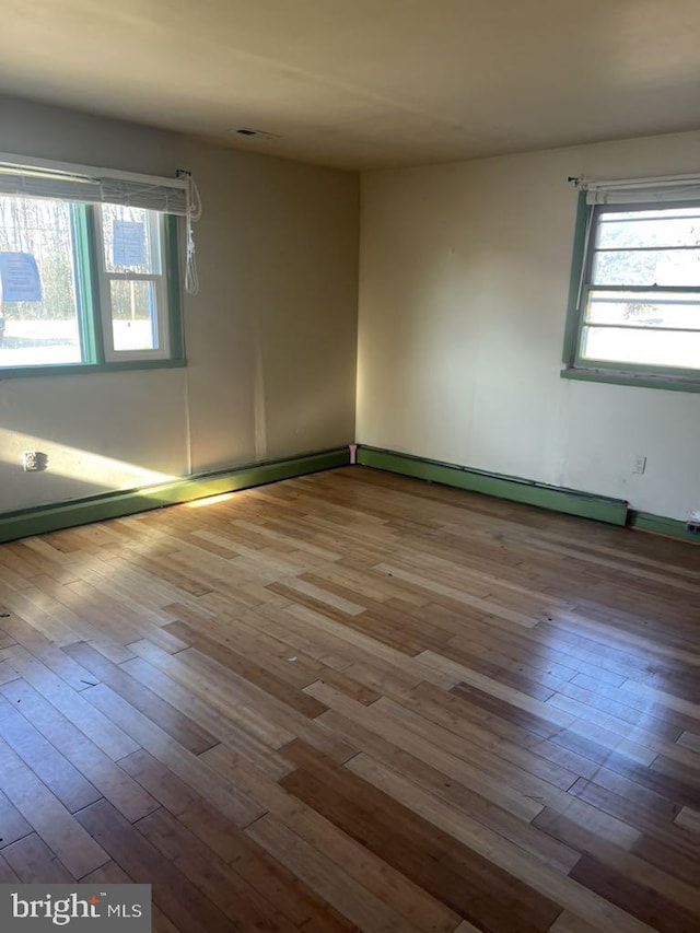 6640 Pomfret Rd, La Plata, MD 20646 - spare room featuring healthy amount of natural light, hardwood / wood-style floors, and baseboard heating