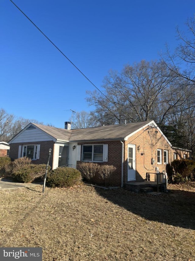 6640 Pomfret Rd, La Plata, MD 20646 - ranch-style house with brick siding and a chimney