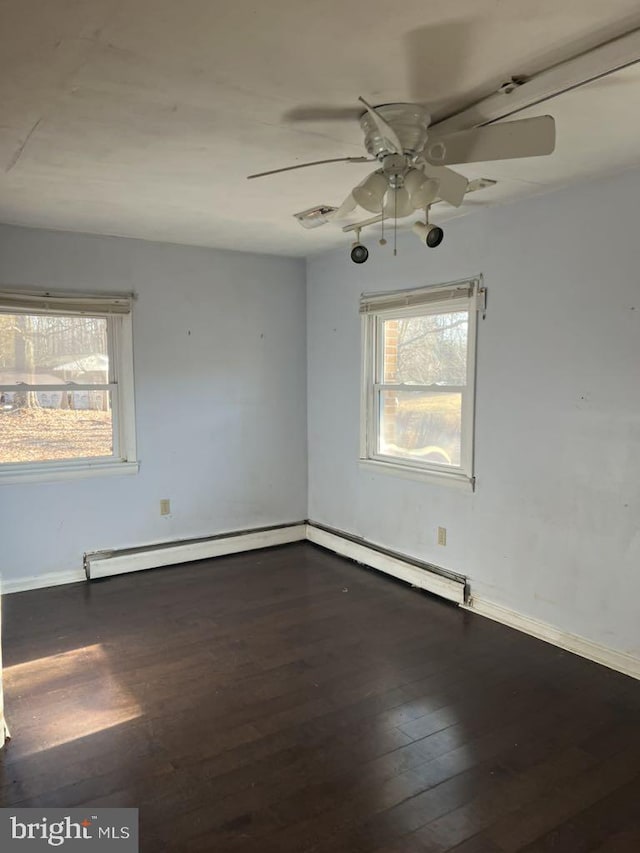 6640 Pomfret Rd, La Plata, MD 20646 - unfurnished room featuring a ceiling fan, dark wood finished floors, baseboards, and a baseboard heating unit
