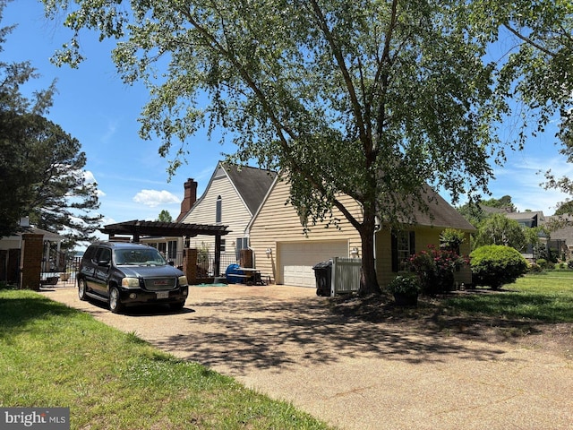 2515 Manion Dr, Williamsburg, VA 23185 - view of property exterior with driveway, an attached garage, a chimney, and a lawn