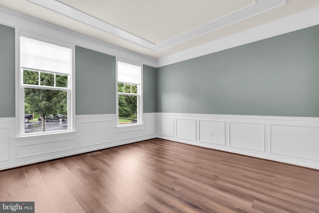 40578 Sculpin Ct, Aldie, VA 20105 - spare room with a wainscoted wall, a raised ceiling, wood finished floors, and ornamental molding