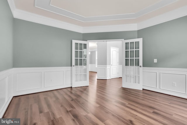 40578 Sculpin Ct, Aldie, VA 20105 - unfurnished room with french doors, ornamental molding, a wainscoted wall, wood finished floors, and a decorative wall