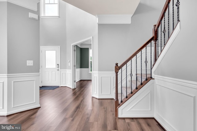 40578 Sculpin Ct, Aldie, VA 20105 - foyer featuring healthy amount of natural light, wainscoting, dark wood-style flooring, stairway, and a decorative wall