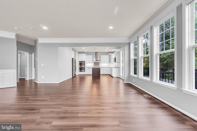 40578 Sculpin Ct, Aldie, VA 20105 - unfurnished living room featuring dark wood-style floors, ornamental molding, recessed lighting, and baseboards