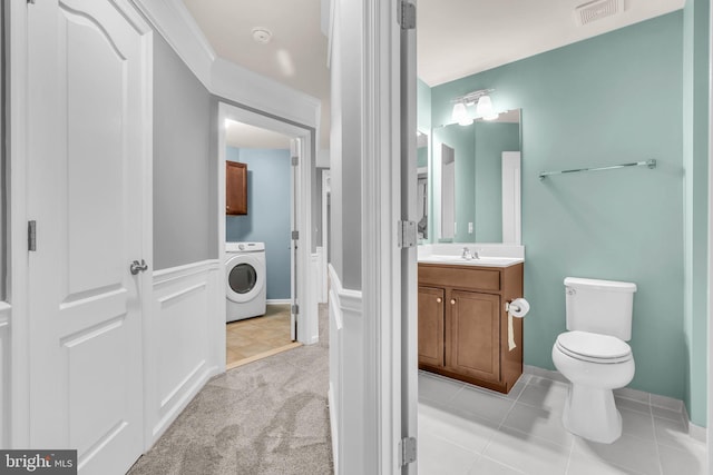 40578 Sculpin Ct, Aldie, VA 20105 - bathroom with washer / clothes dryer, vanity, toilet, a wainscoted wall, and tile patterned floors
