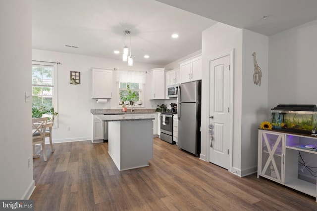 12 Parkview Dr, Carlisle, PA 17013 - kitchen featuring stainless steel appliances, a center island, white cabinetry, dark wood-style floors, and light stone counters