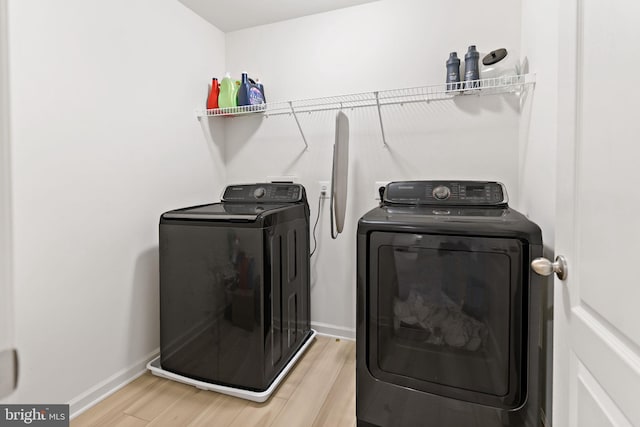 127 Stager Ave, Falling Waters, WV 25419 - washroom with washing machine and dryer, wood finished floors, and baseboards