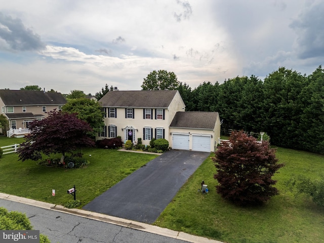 7 Meadow Lark Dr, Milford, DE 19963 - colonial home featuring an attached garage, asphalt driveway, and a front yard