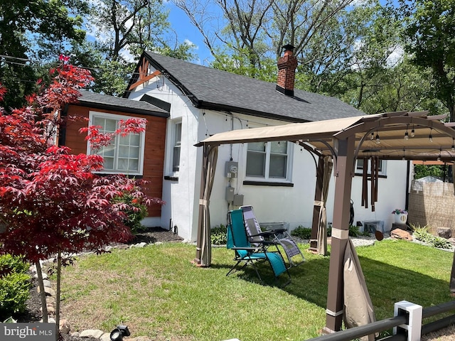 209 Hewitt Rd, Williamstown, NJ 08094 - view of front of house with a chimney, a shingled roof, and stucco siding