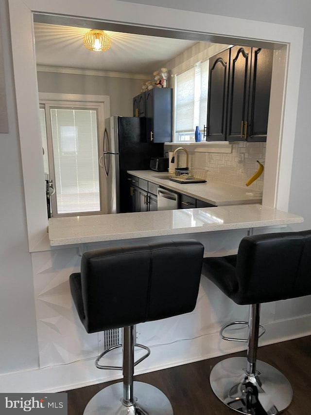 209 Hewitt Rd, Williamstown, NJ 08094 - kitchen with backsplash, ornamental molding, a breakfast bar, stainless steel appliances, and a sink