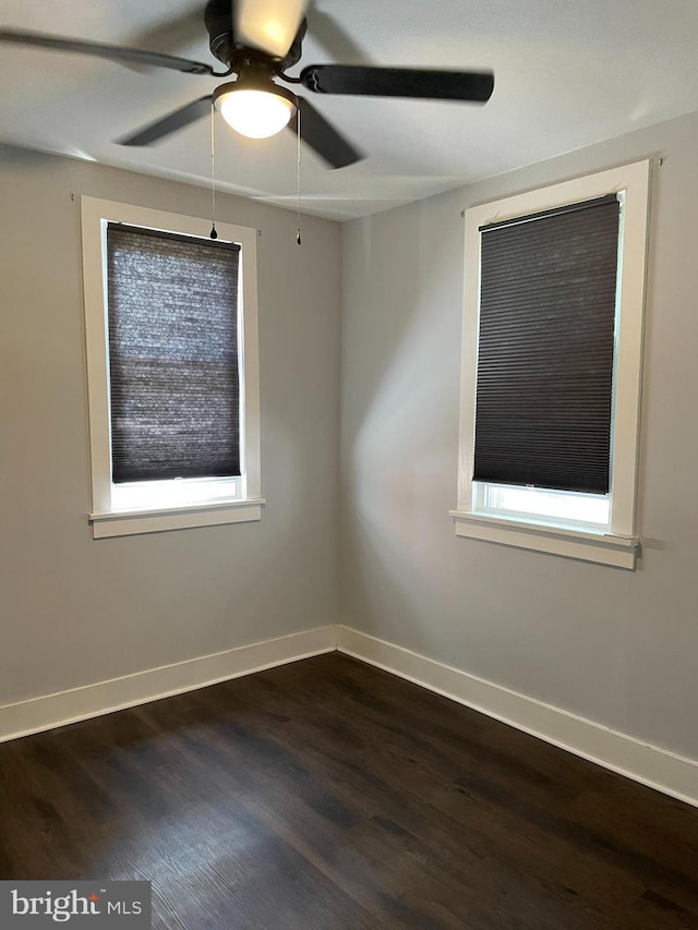 209 Hewitt Rd, Williamstown, NJ 08094 - unfurnished room with dark wood-type flooring, a ceiling fan, and baseboards