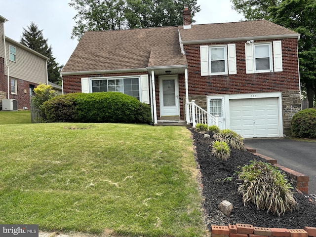 227 Rolling Hill Rd, Elkins Park, PA 19027 - split level home featuring cooling unit, a chimney, an attached garage, a front lawn, and driveway