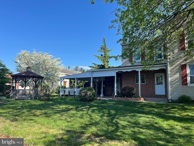 209 S Cherry St, Myerstown, PA 17067 - rear view of house featuring a gazebo, a yard, and brick siding