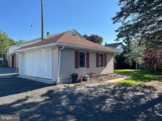 209 S Cherry St, Myerstown, PA 17067 - view of home's exterior with a detached garage, asphalt driveway, and a shingled roof