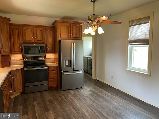 209 S Cherry St, Myerstown, PA 17067 - kitchen with appliances with stainless steel finishes, washing machine and dryer, ceiling fan, light countertops, and dark wood-style flooring