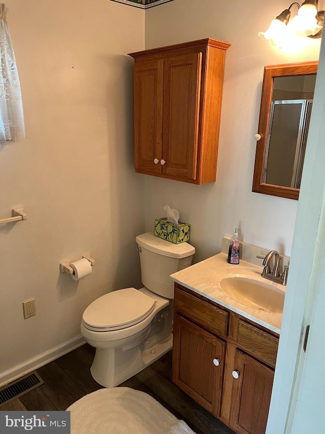 209 S Cherry St, Myerstown, PA 17067 - bathroom with toilet, vanity, wood finished floors, a shower with door, and baseboards