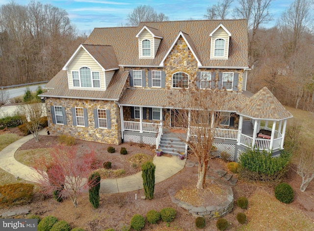 5 Cross Point Dr, Owings, MD 20736 - view of front facade featuring stone siding, a porch, and roof with shingles
