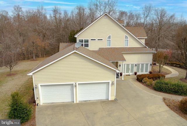 5 Cross Point Dr, Owings, MD 20736 - view of side of property featuring french doors, driveway, and roof with shingles