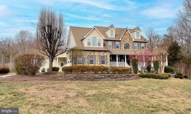 5 Cross Point Dr, Owings, MD 20736 - shingle-style home with covered porch, a front yard, and stone siding