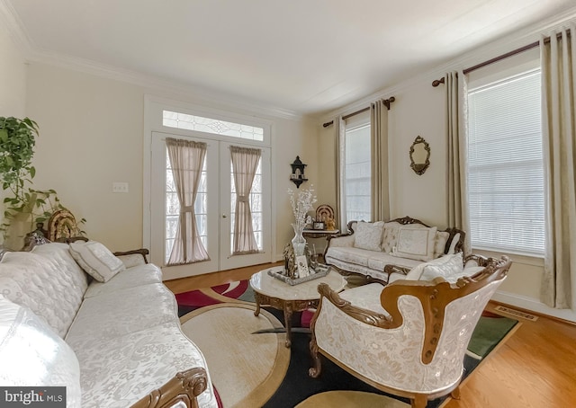 5 Cross Point Dr, Owings, MD 20736 - living area with french doors, crown molding, wood finished floors, plenty of natural light, and baseboards