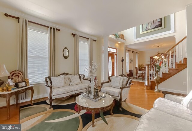 5 Cross Point Dr, Owings, MD 20736 - living area with stairs, wood finished floors, baseboards, and a chandelier