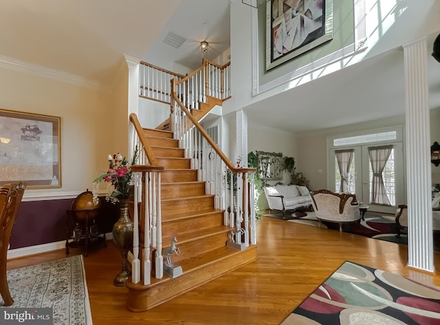 5 Cross Point Dr, Owings, MD 20736 - staircase featuring wood finished floors, ornamental molding, a towering ceiling, and french doors