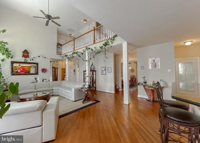 5 Cross Point Dr, Owings, MD 20736 - living area featuring a high ceiling, ceiling fan, wood finished floors, stairway, and baseboards