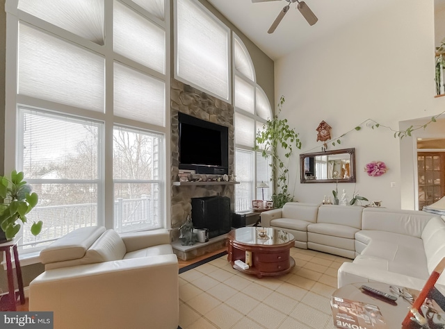 5 Cross Point Dr, Owings, MD 20736 - living area with a fireplace, healthy amount of natural light, a ceiling fan, and vaulted ceiling