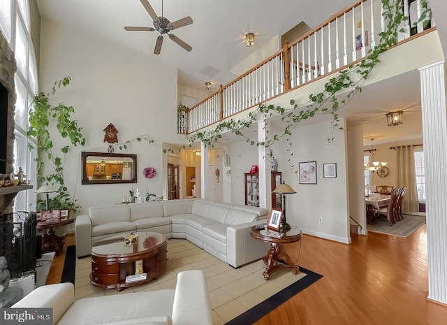 5 Cross Point Dr, Owings, MD 20736 - living area featuring a high ceiling, ceiling fan, wood finished floors, a chandelier, and baseboards