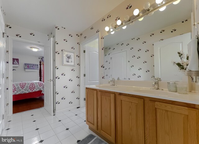 5 Cross Point Dr, Owings, MD 20736 - bathroom featuring double vanity, ensuite bathroom, tile patterned flooring, and baseboards