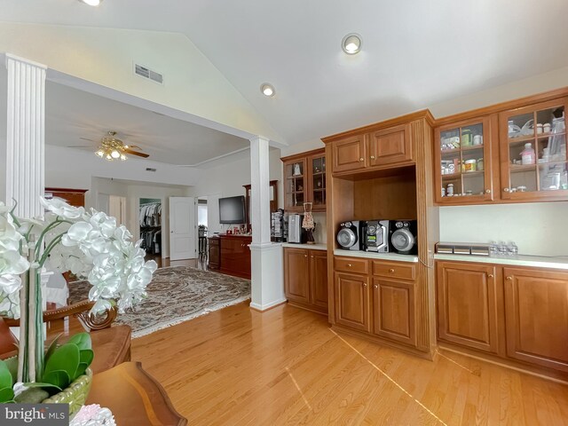 5 Cross Point Dr, Owings, MD 20736 - kitchen with light countertops, vaulted ceiling, light wood-style flooring, brown cabinets, and glass insert cabinets