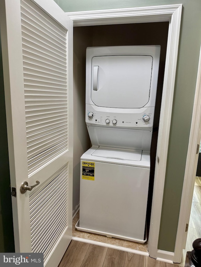 7423 Rigby Pl, Elkridge, MD 21075 - laundry room featuring stacked washer / drying machine and wood finished floors