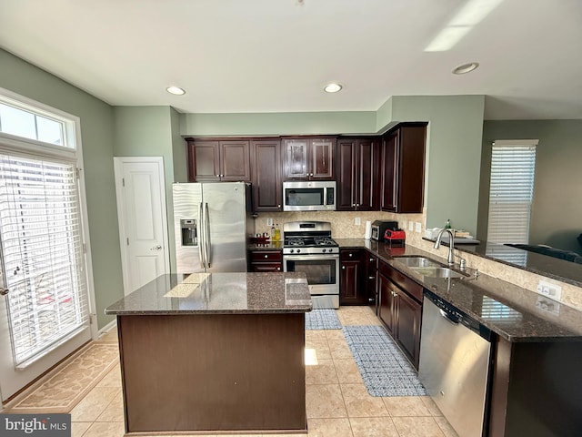 7423 Rigby Pl, Elkridge, MD 21075 - kitchen with stainless steel appliances, a sink, light tile patterned floors, dark stone counters, and recessed lighting