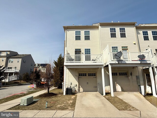 7423 Rigby Pl, Elkridge, MD 21075 - rear view of property featuring a garage, concrete driveway, a balcony, and a residential view