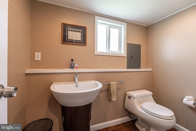 7129 Chandler Ave, Pennsauken, NJ 08110 - bathroom featuring electric panel, baseboards, toilet, and ornamental molding