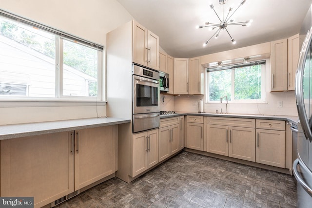 7129 Chandler Ave, Pennsauken, NJ 08110 - kitchen featuring a warming drawer, appliances with stainless steel finishes, a chandelier, and tasteful backsplash